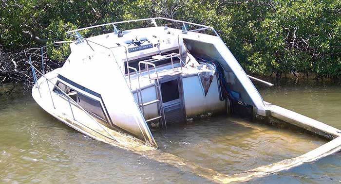 abandoned-powerboat-sinking-in-swamp-water